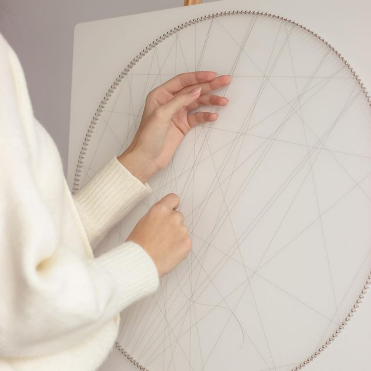 Custom string art portrait displayed on wall